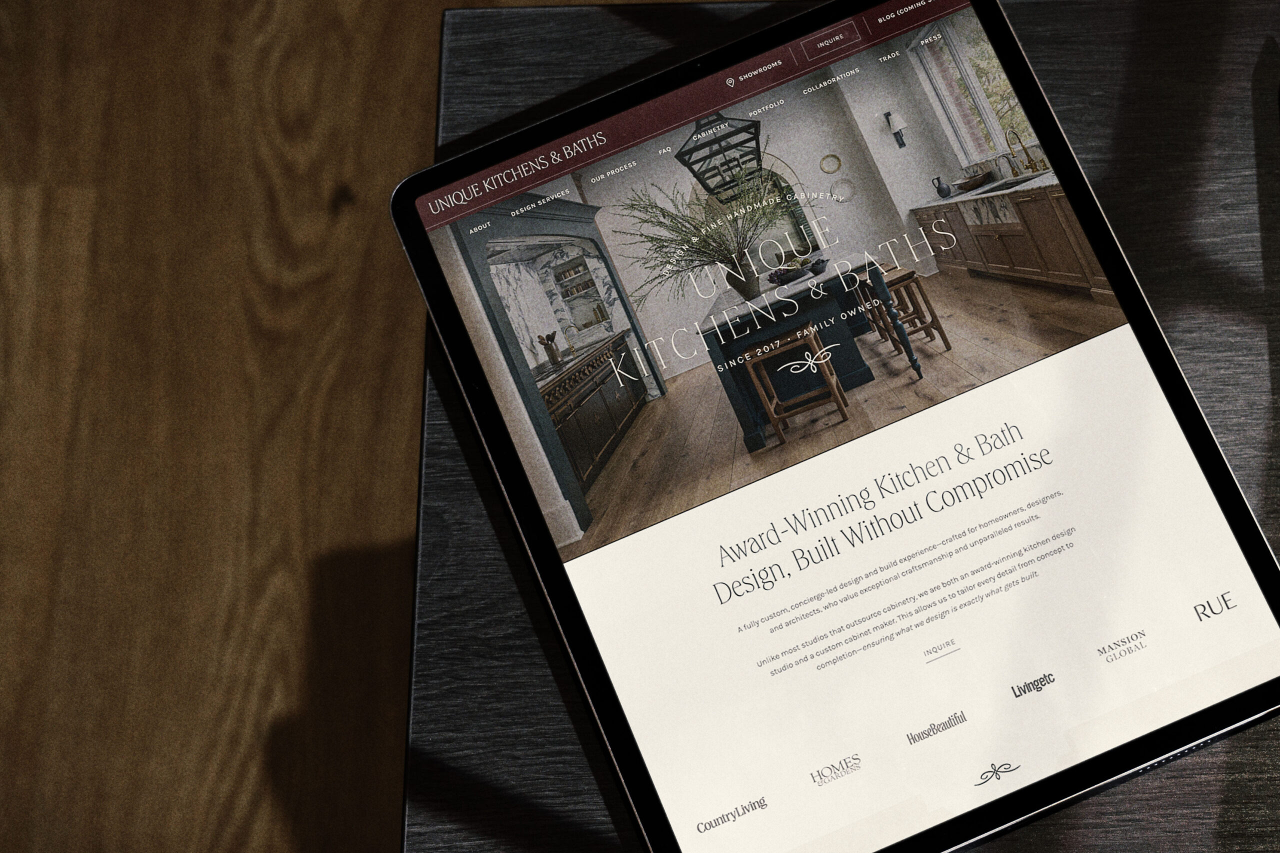 Laptop displaying a luxury interior design portfolio website on a sofa, highlighting an elevated online experience for high-end clients.
